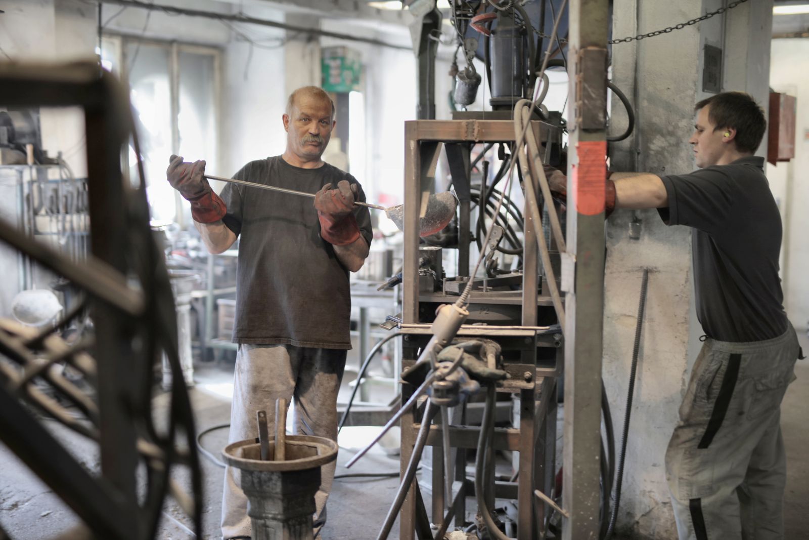 Technicians working together at production equipment
